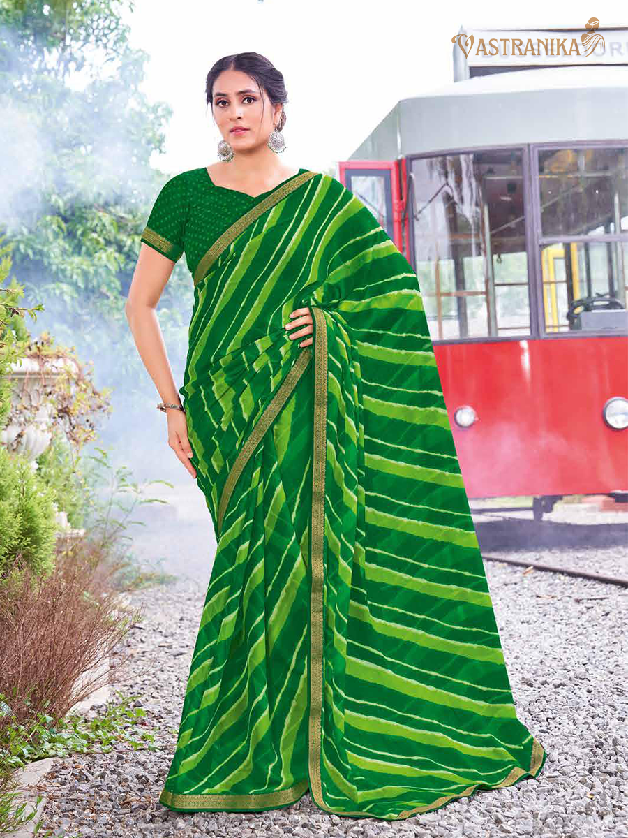 Model wearing a lush green pure moss crepe saree adorned with batik and bandhej prints, paired with a matching printed blouse – from Vastranika Exclusive 45043, ideal for Sawan and festive occasions.

