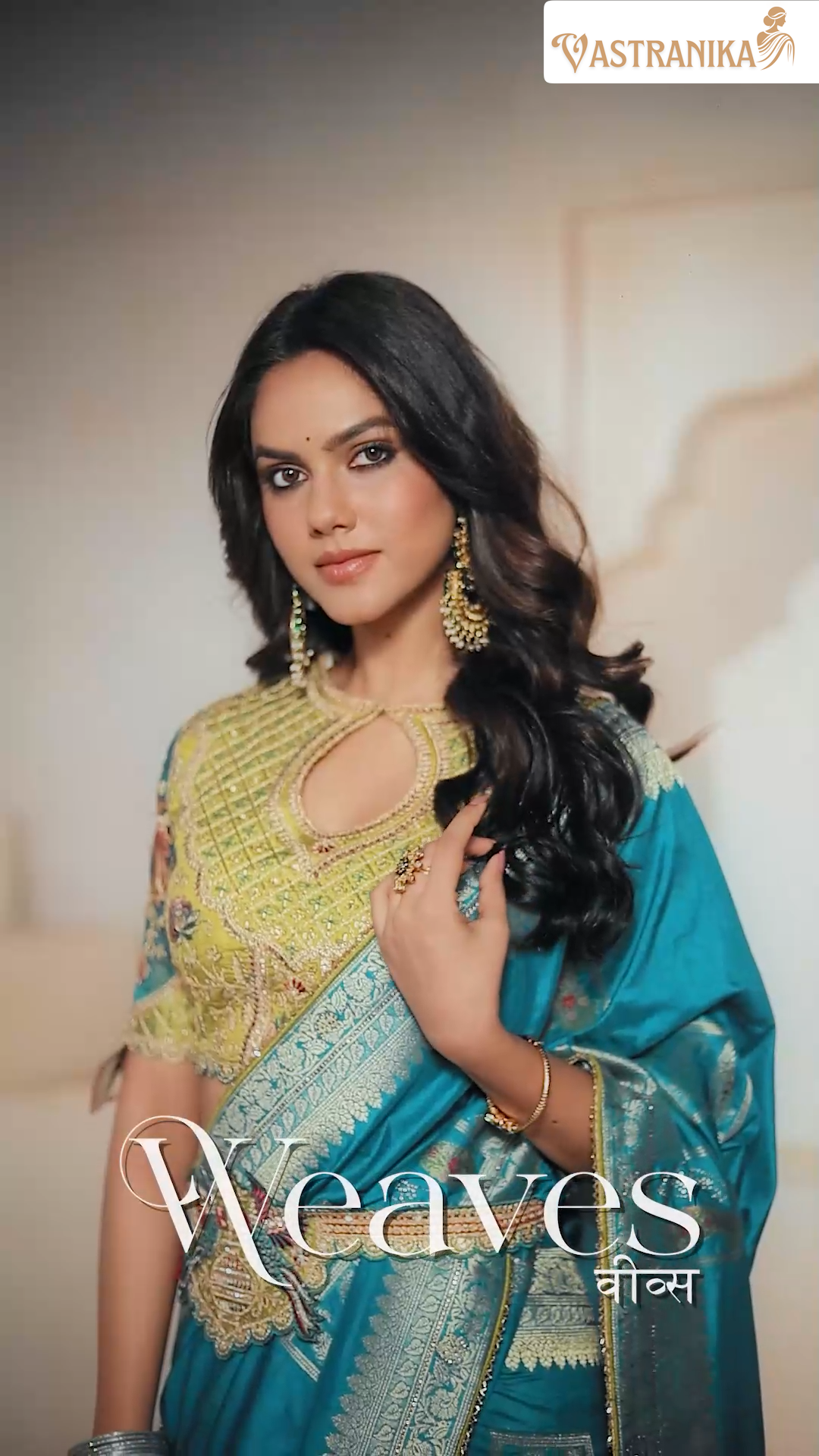Model draped in a firozi premium silk saree featuring intricate heavy weaving and grand pallu, paired with a designer and contrast blouse – from Vastranika's Weaves collection.