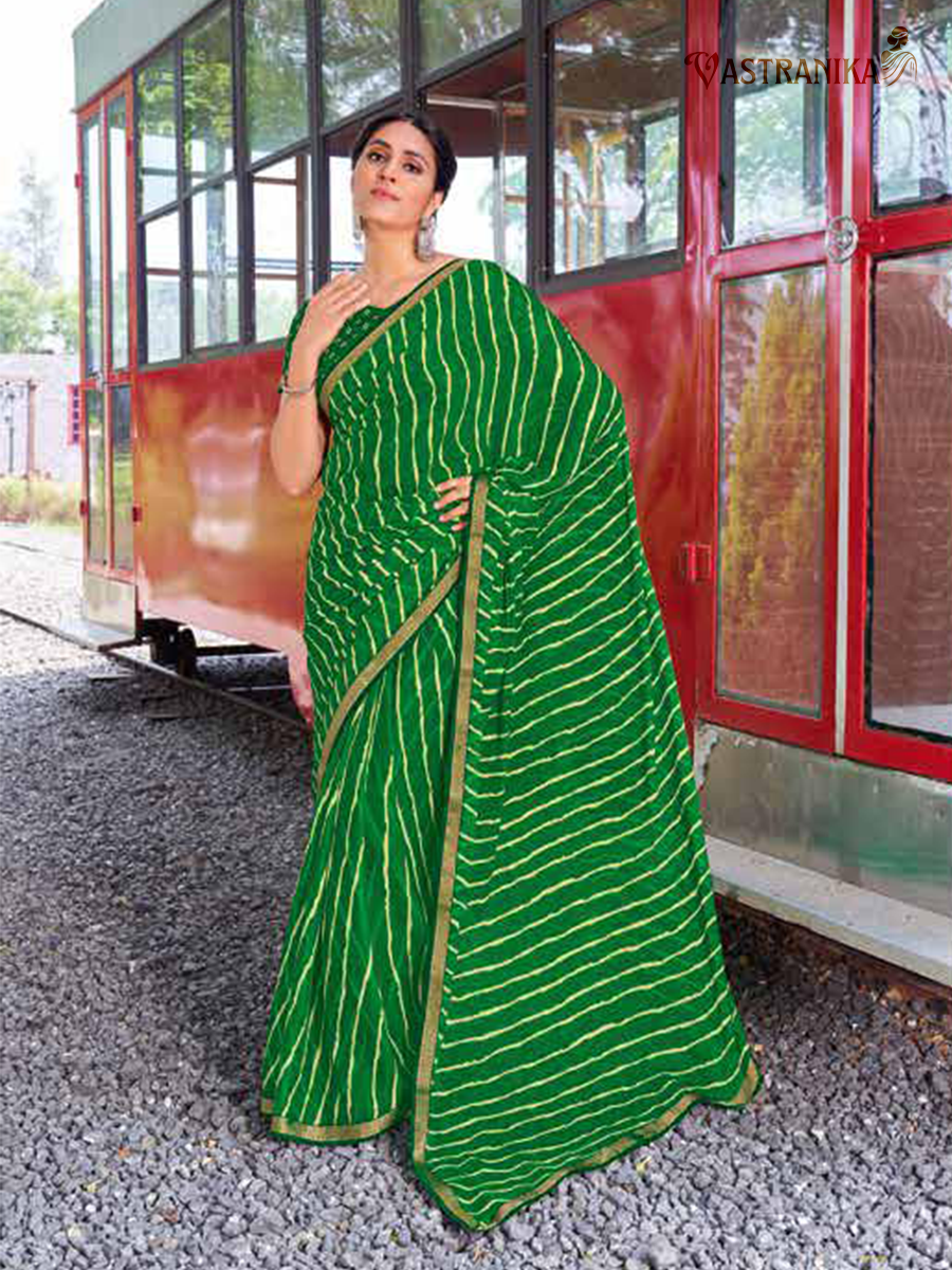 Model draped in a vibrant green pure moss crepe saree featuring bold leheriya design and ornate heavy zari border, paired with a printed blouse – Vastranika 45045.